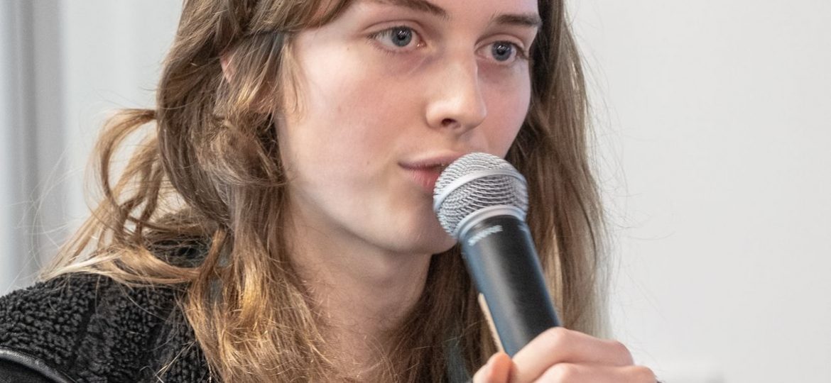 Free software developer Alyssa Ross talking through microphone